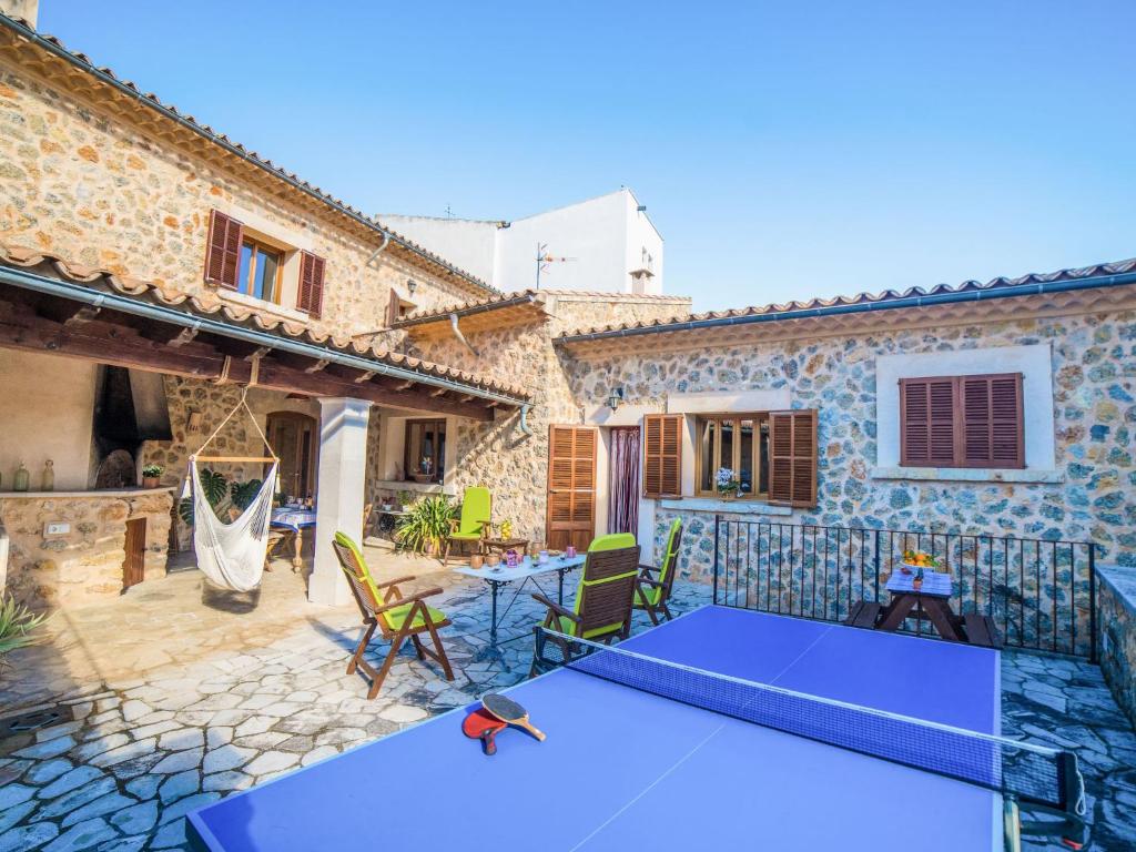 a house with a blue ping pong table on a patio at Holiday Home Son Trobat by Interhome in Mancor del Valle
