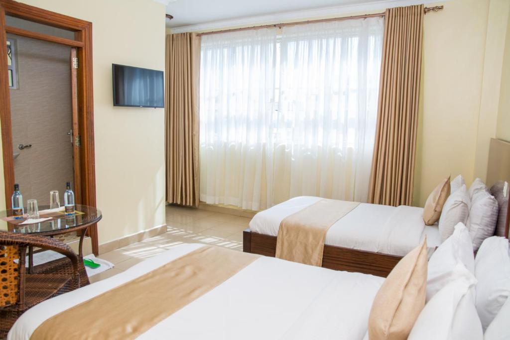 Postel nebo postele na pokoji v ubytování Delfirm Hotel