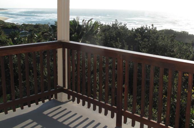 a wooden balcony with a view of the ocean at 57 Simon Van Der Stel Street in Port Edward