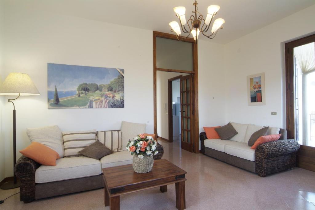 a living room with two couches and a table at The Sea View Mountain Apartment in Fasano