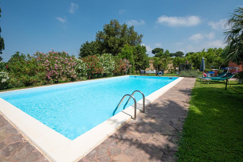 a swimming pool in the yard of a house at Poggio degli Oleandri in Nettuno