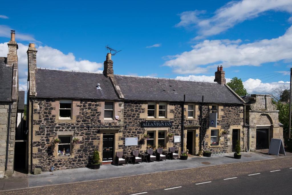 an old stone building on the corner of a street at Allanton Inn in Allanton