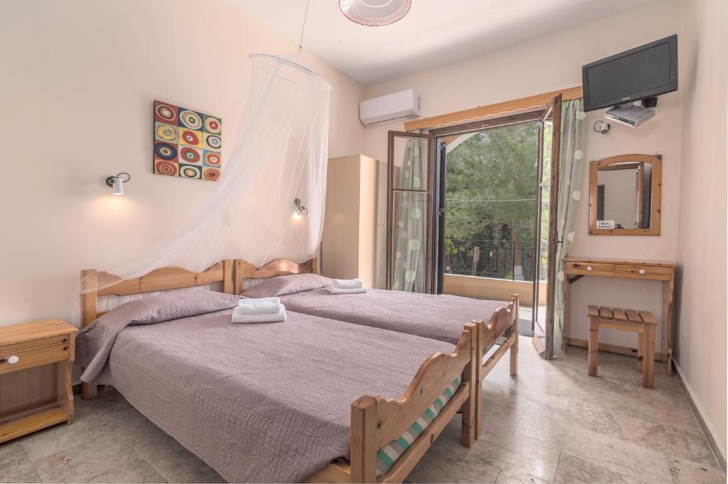 A bed or beds in a room at Andreas Apartments
