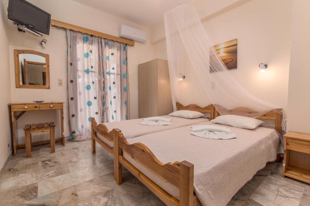 A bed or beds in a room at Andreas Apartments