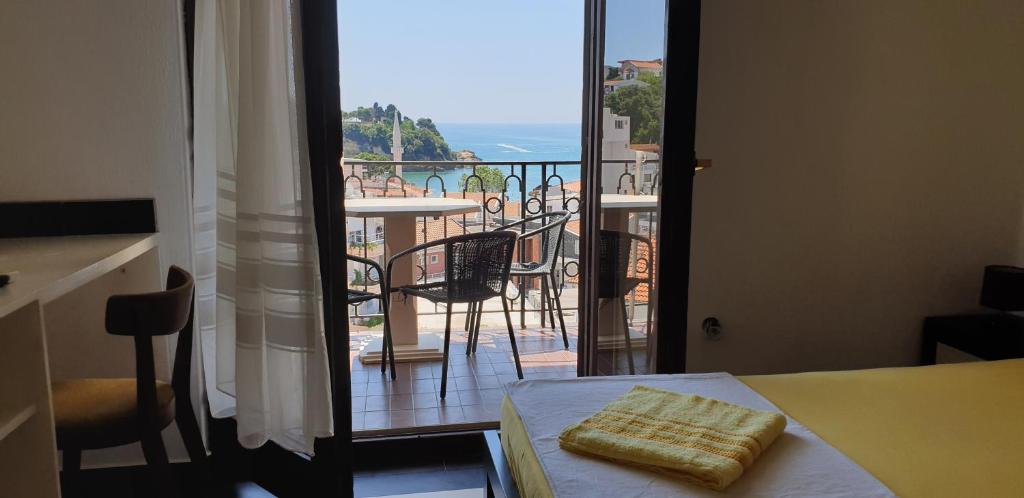 a room with a view of a balcony with a table at Apartments Prag in Ulcinj