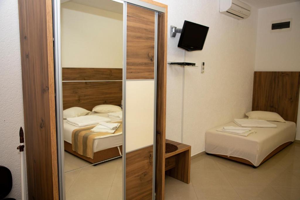 a room with two beds and a sliding glass door at Villa Andjelina in Budva