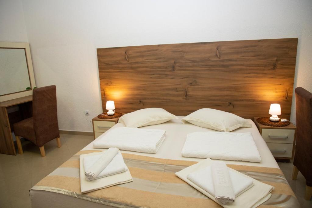 a bedroom with a large bed with two white pillows at Villa Andjelina in Budva