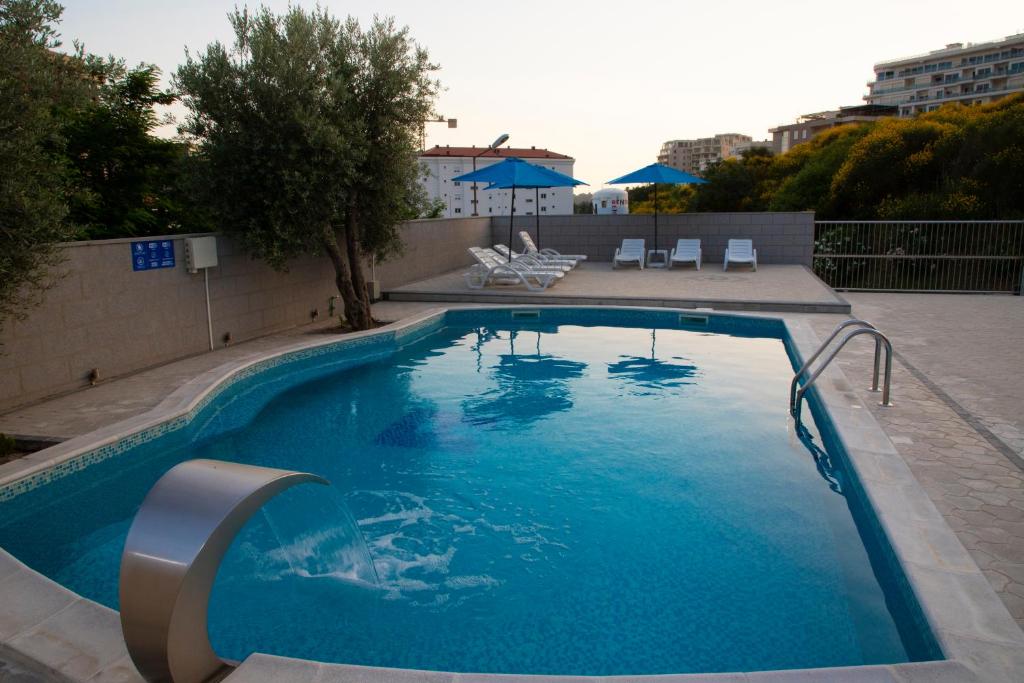 a large swimming pool with blue water at Villa Andjelina in Budva