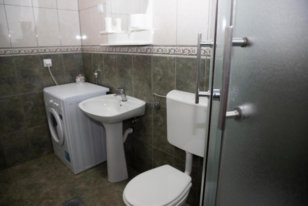 a small bathroom with a toilet and a sink at Villa Andjelina in Budva