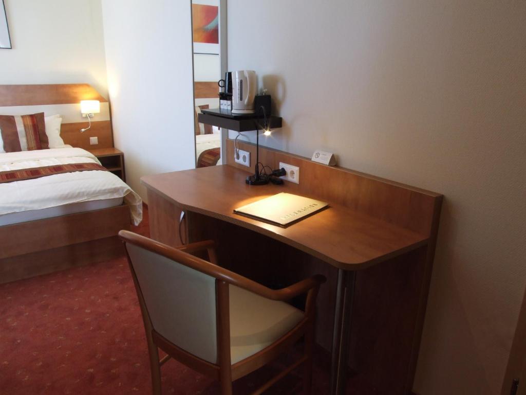 Postel nebo postele na pokoji v ubytování Boutique Hotel Wolfsburg
