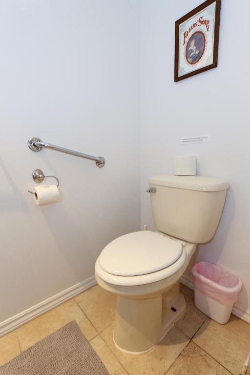 a bathroom with a white toilet in a room at Cedar Drive Inn in Crysler