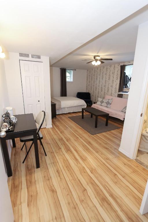 a living room with a table and a bedroom at Cedar Drive Inn in Crysler