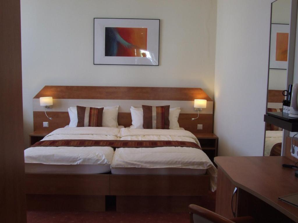 Postel nebo postele na pokoji v ubytování Boutique Hotel Wolfsburg