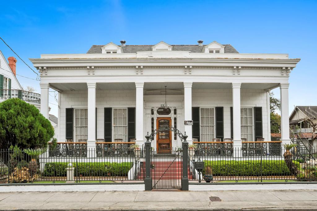 a white house with a gate in front of it at Ashton's Bed and Breakfast in New Orleans