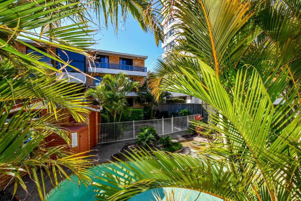 an aerial view of a building with palm trees at La Mer Apartments in Mooloolaba