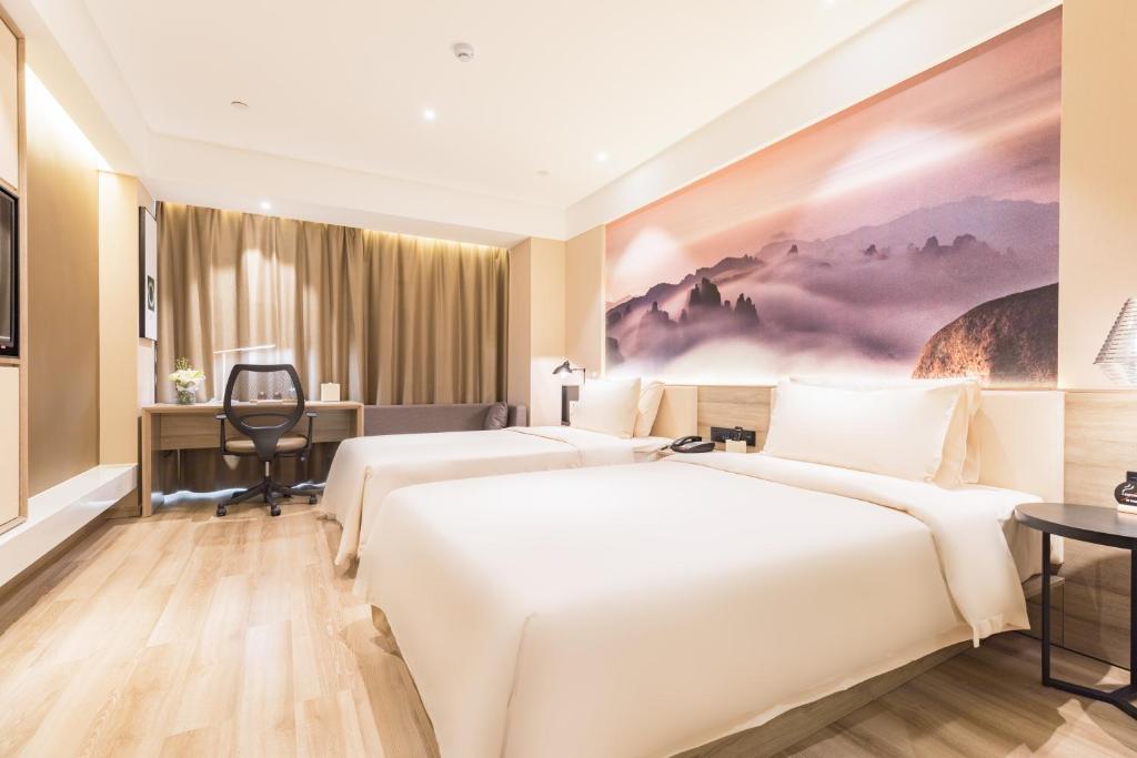 Postel nebo postele na pokoji v ubytování Atour Hotel Qingdao Airport Chengyang Wanxianghui
