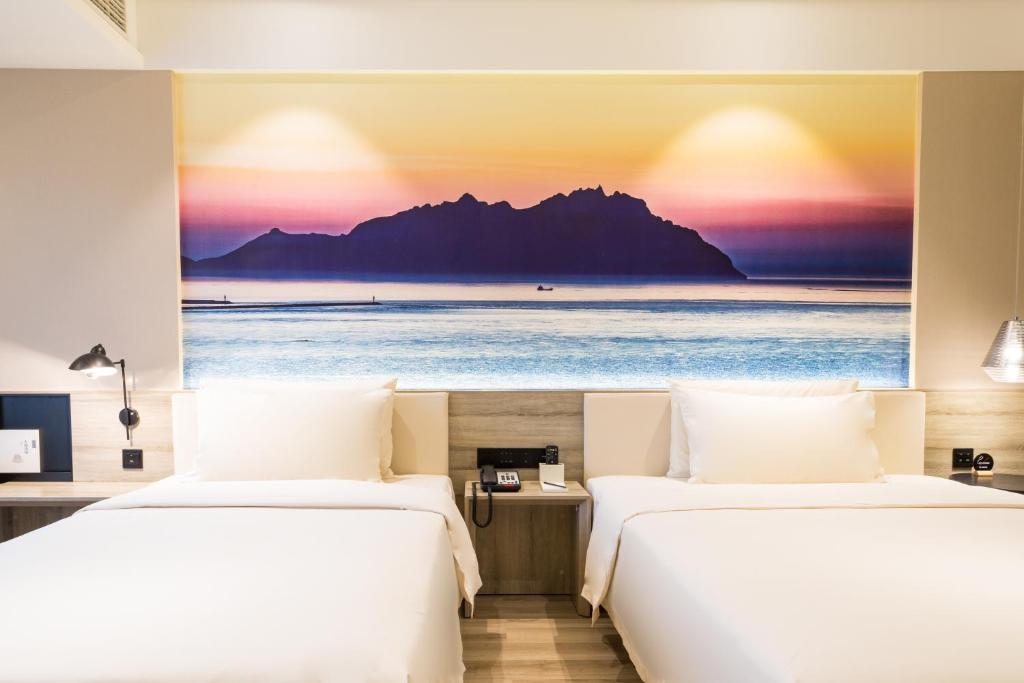 Postel nebo postele na pokoji v ubytování Atour Hotel Qingdao Airport Chengyang Wanxianghui