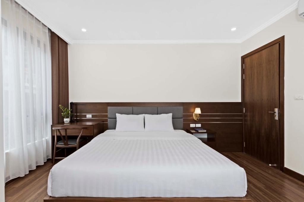 Postel nebo postele na pokoji v ubytování Newsky Serviced Apartment