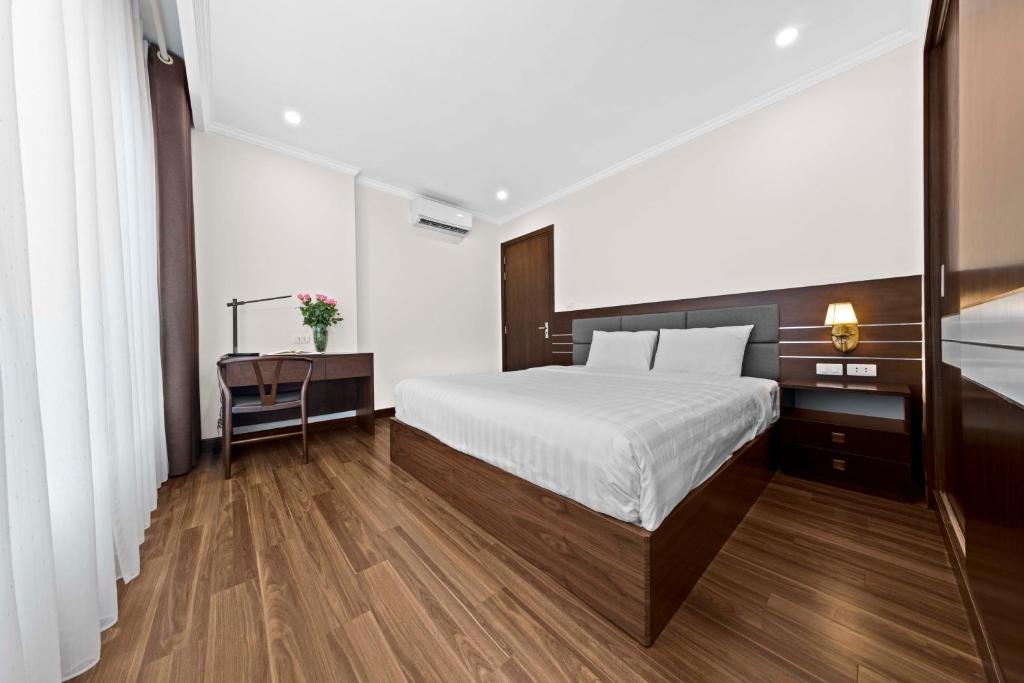 Postel nebo postele na pokoji v ubytování Newsky Serviced Apartment