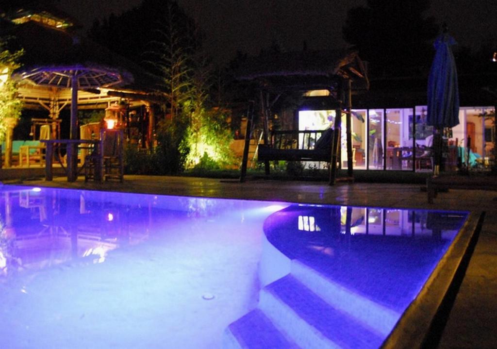 a swimming pool at a resort at night at Bambou House in Aix-en-Provence