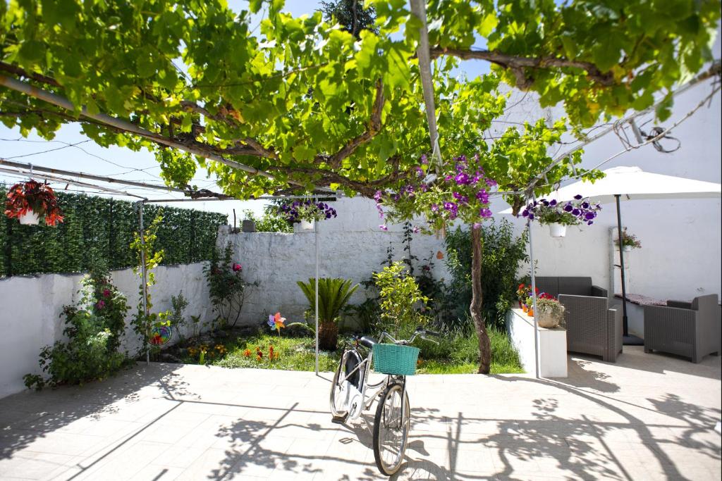 a bike parked in a garden with flowers at Il Segnalibro B&B in Alberobello