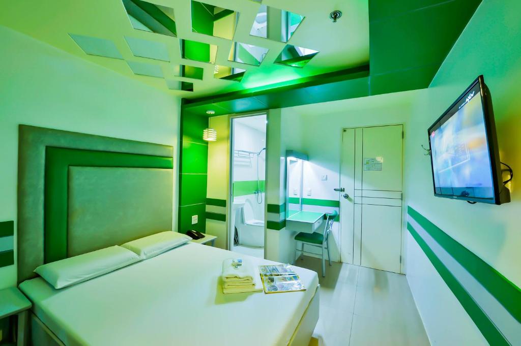 TV a/nebo společenská místnost v ubytování Hotel 99 Monumento