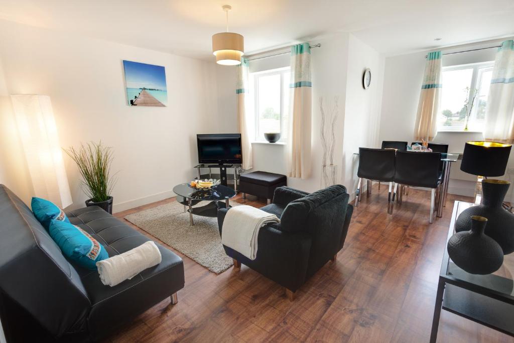 a living room with a couch and chairs and a table at Meridian Apartment Suites in Southend-on-Sea
