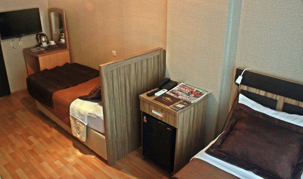A bed or beds in a room at Cmr Aydogan Hotel