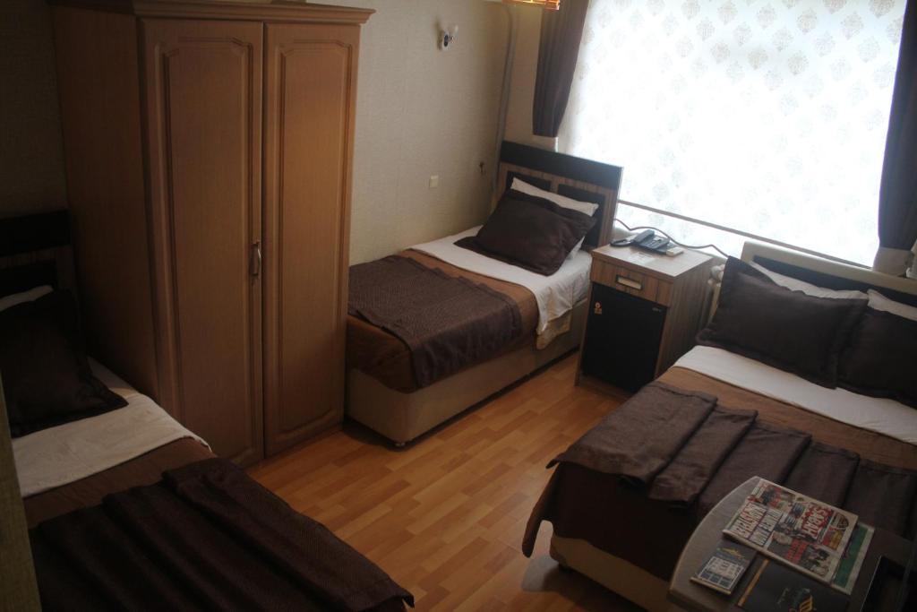 A bed or beds in a room at Cmr Aydogan Hotel