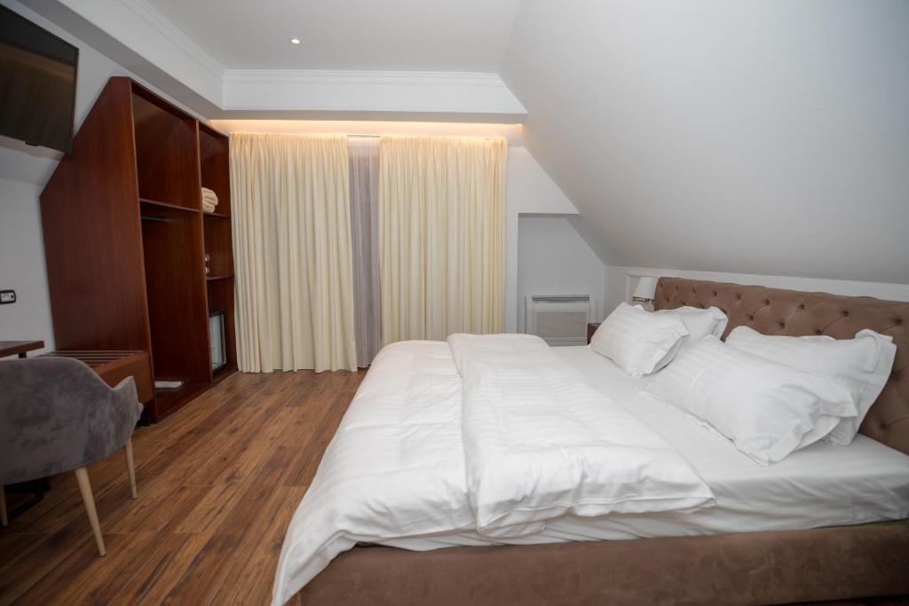 Postel nebo postele na pokoji v ubytování Hotel Vila Zeus
