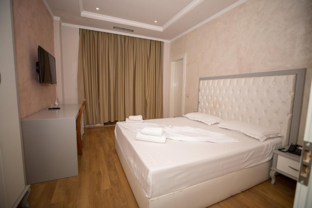 Postel nebo postele na pokoji v ubytování Hotel Vila Zeus