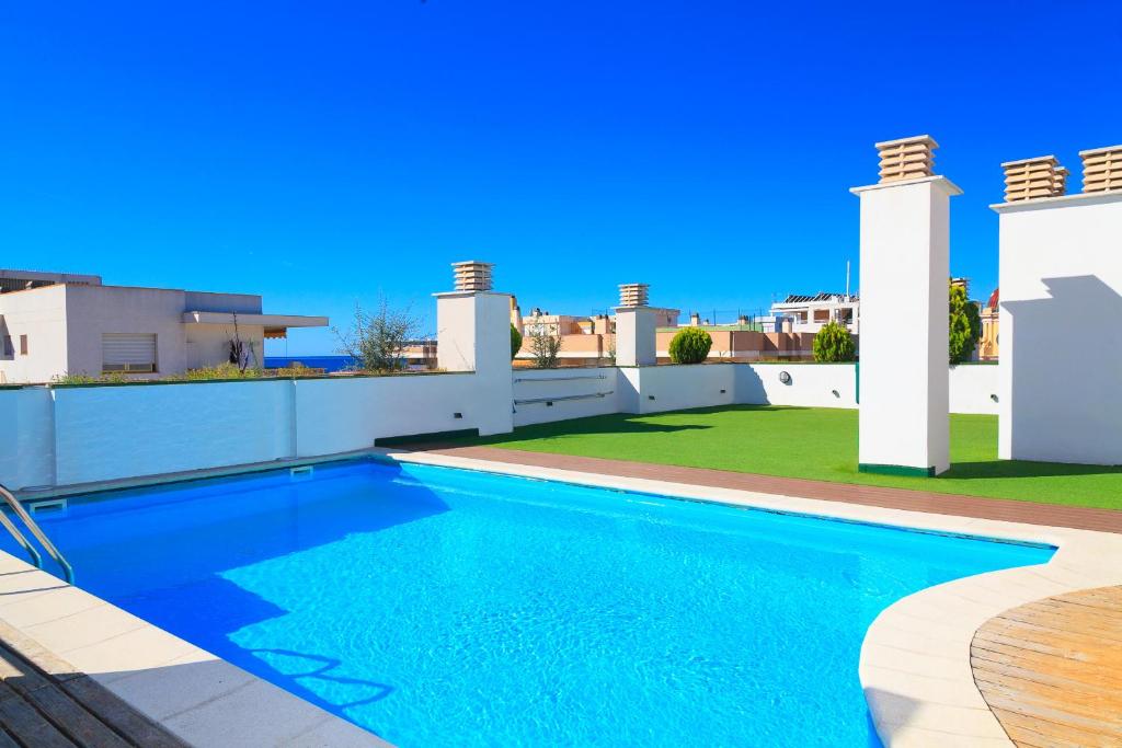 a swimming pool on the roof of a house at UHC Sol i Mar Family Complex in Salou