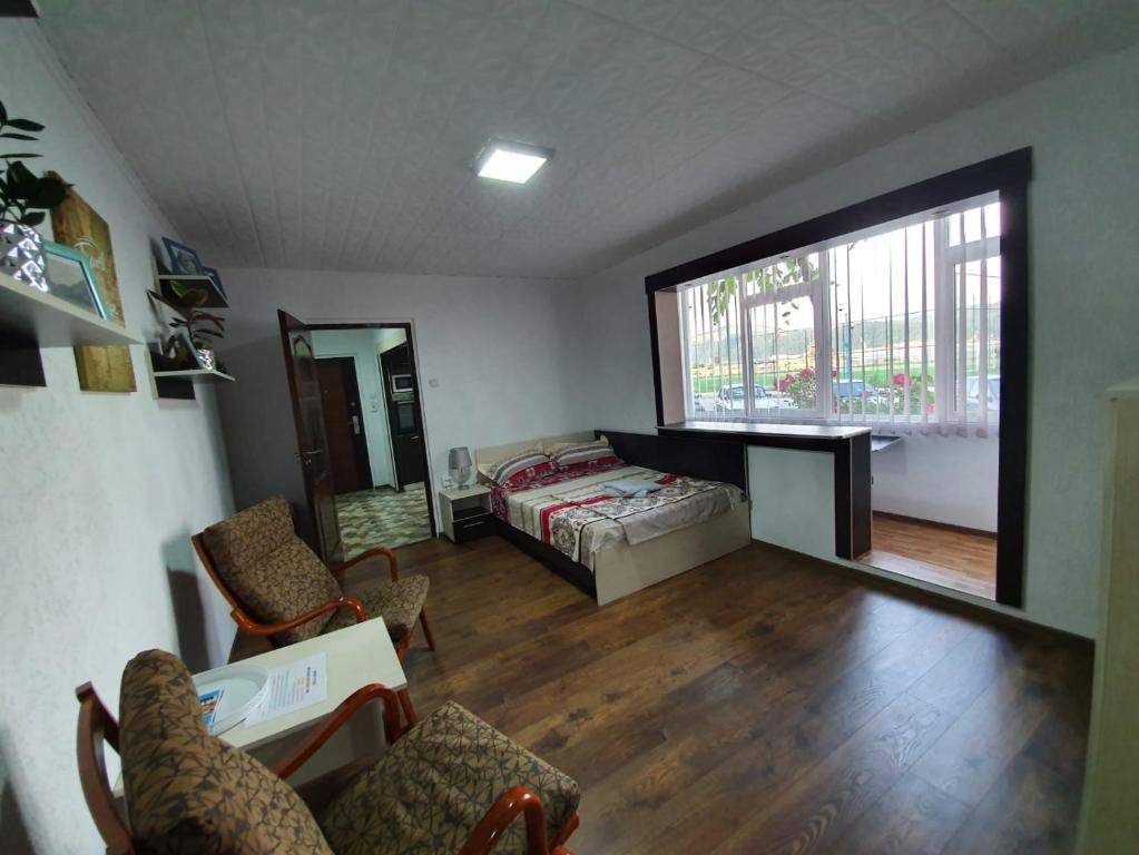 a bedroom with a bed and a large window at Apartment Ada Kaleh in Orşova