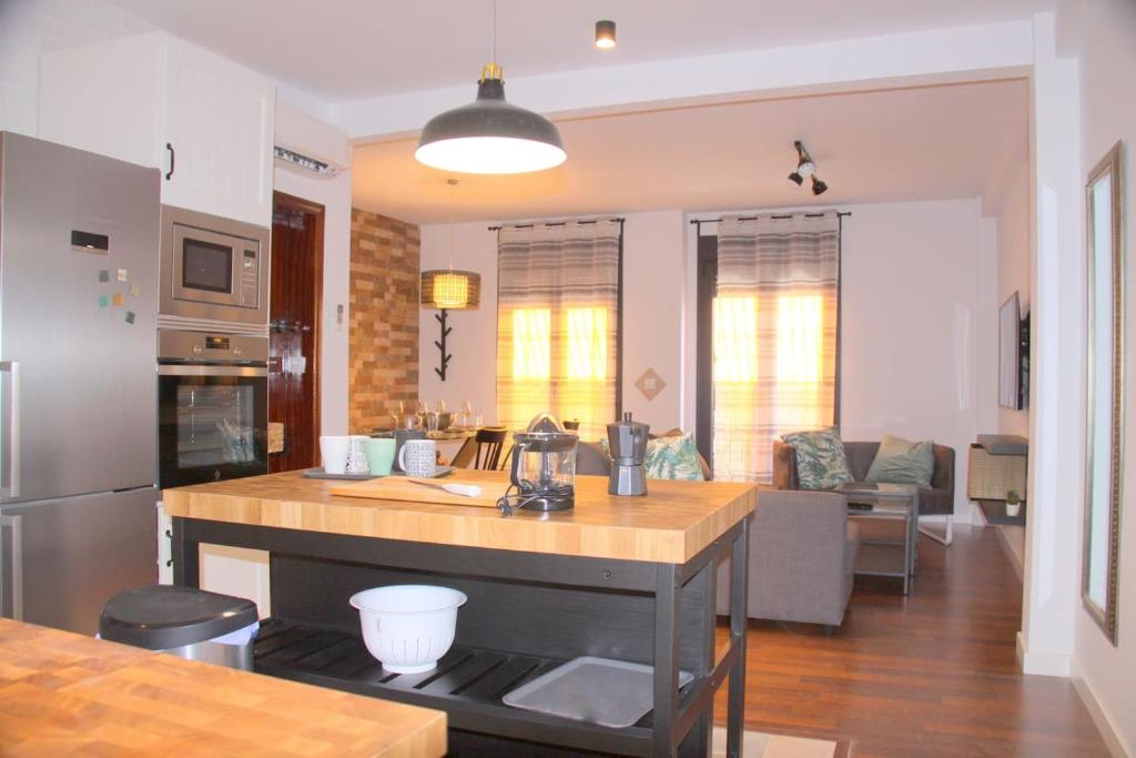 a kitchen with a island in the middle of a room at Muro Center in Seville