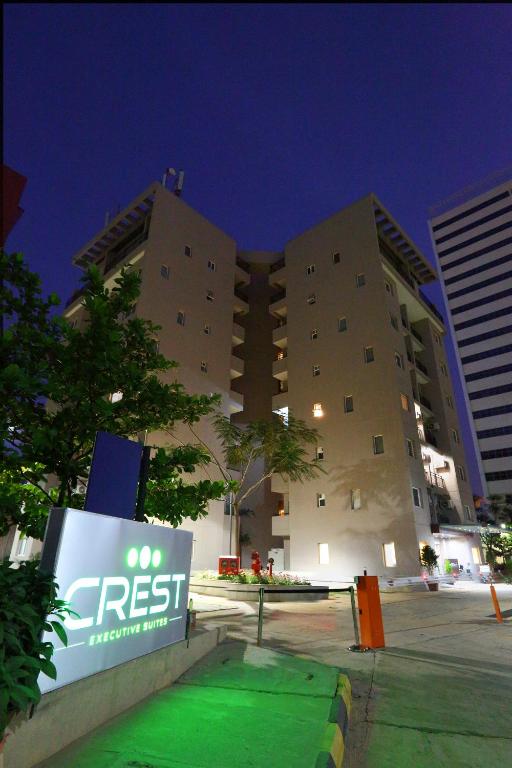 a tall building with a sign in front of it at Crest Executive Suites, Whitefield in Bangalore
