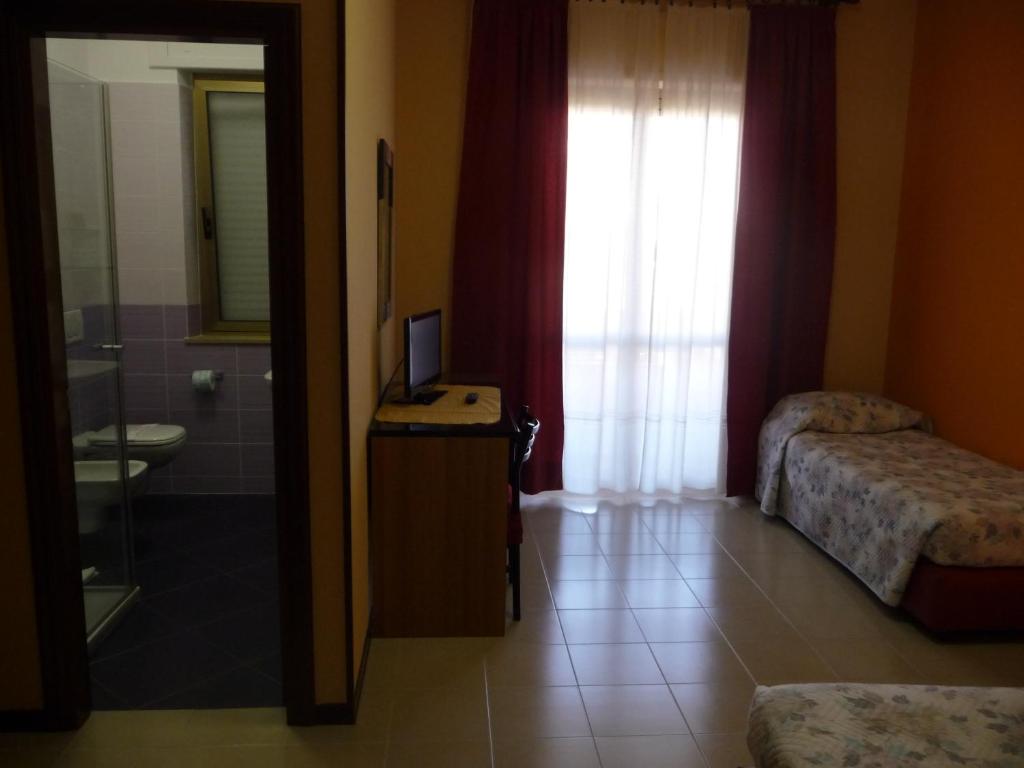 A bed or beds in a room at Hotel Naxos B&B