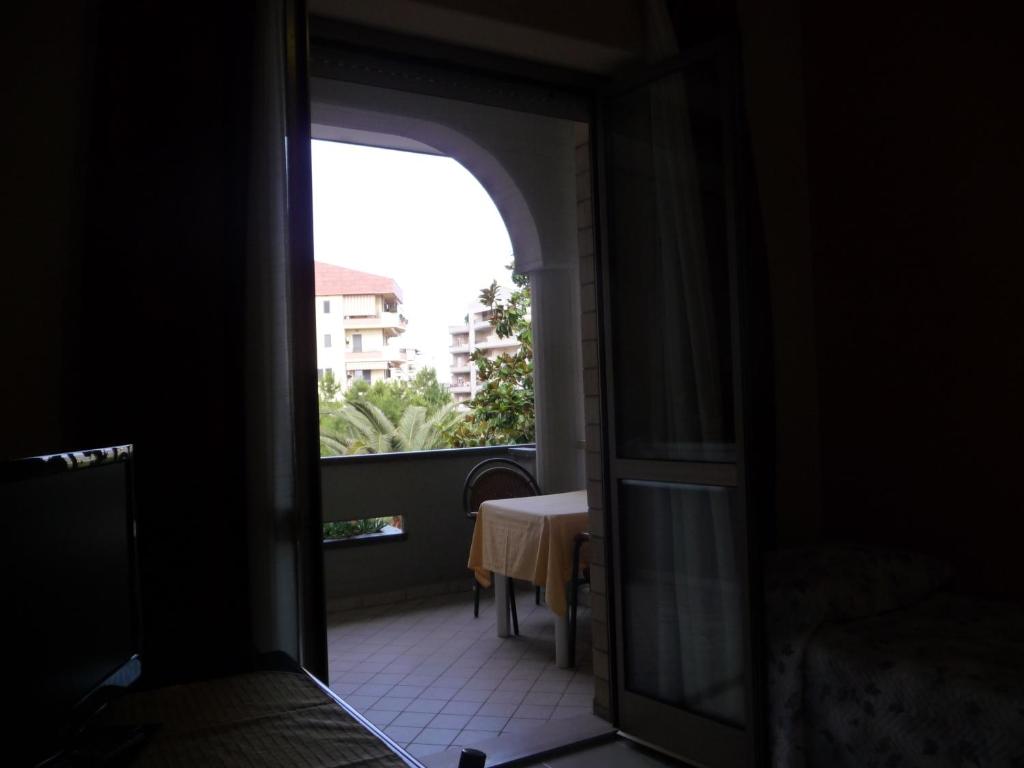 A bed or beds in a room at Hotel Naxos B&B