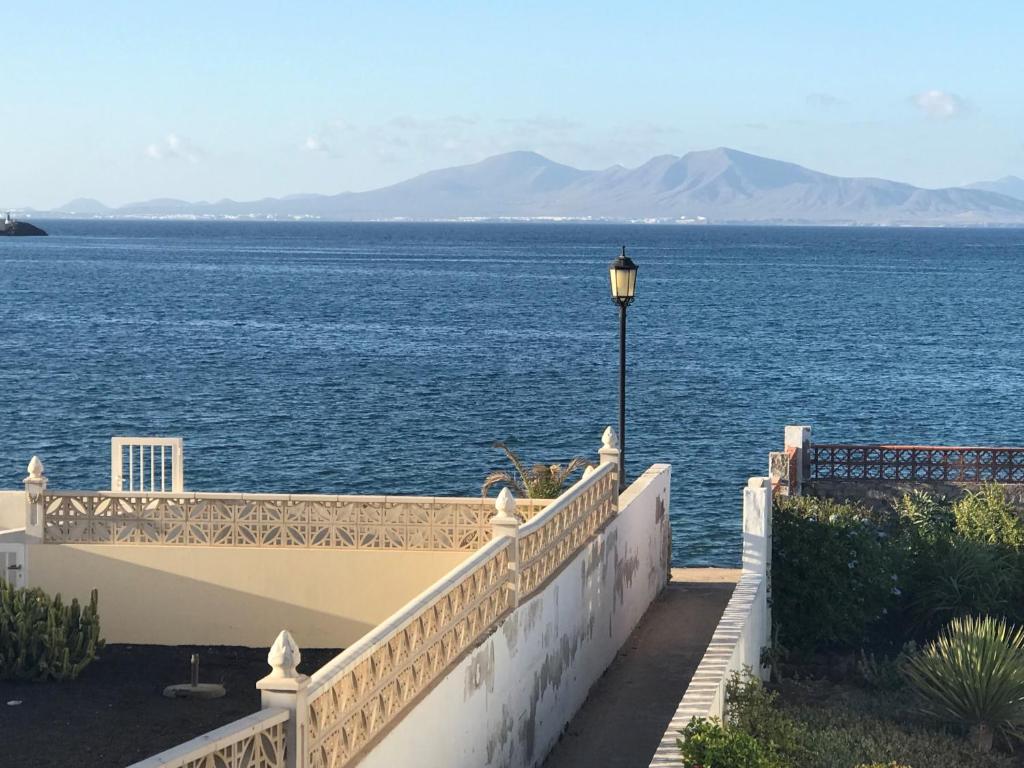 a balcony with a view of the water at Una vista inolvidable in Corralejo