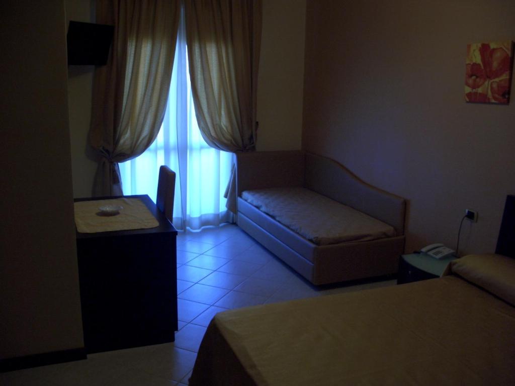 A bed or beds in a room at Hotel Naxos B&B