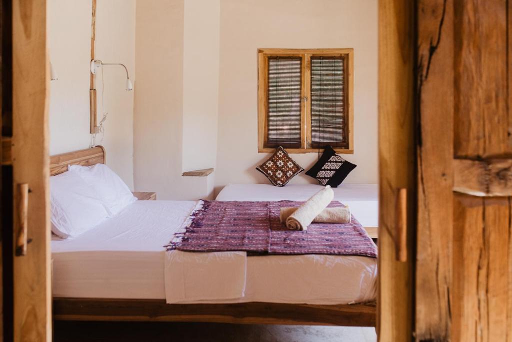 Postel nebo postele na pokoji v ubytování Kalyssa Beach Bungalows
