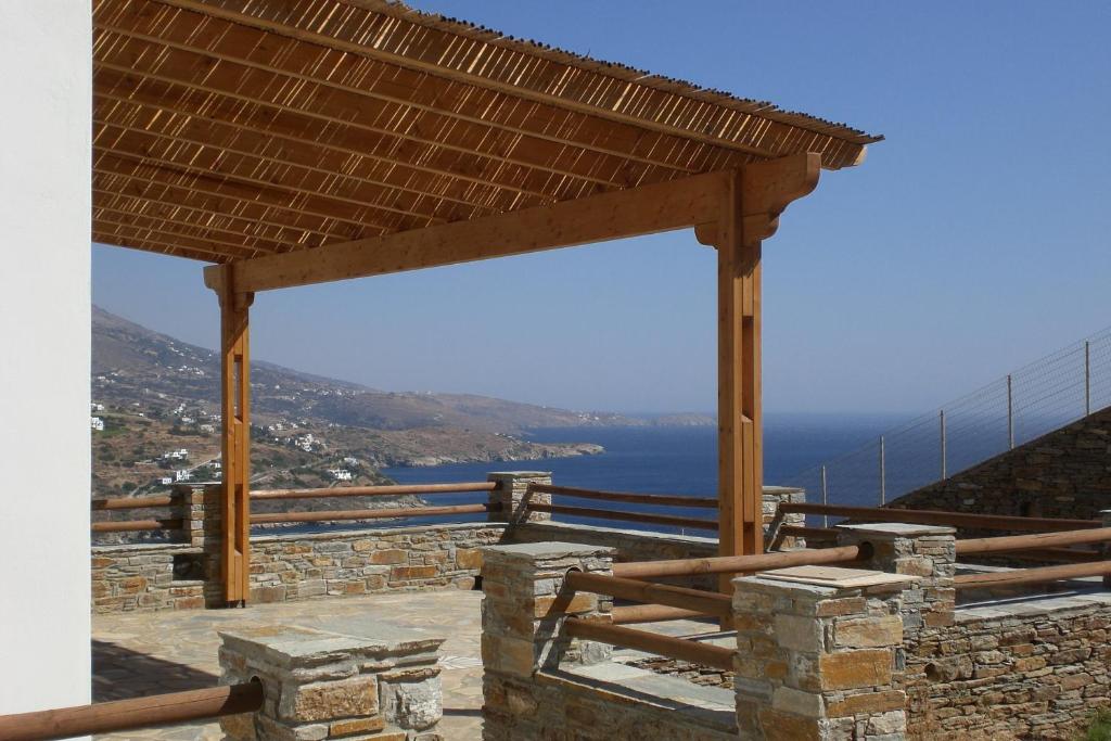 a wooden pavilion with a view of the ocean at Monolithos Villas in Kipri