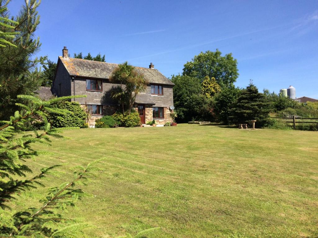 an old house with a large grass yard at Trecorme Barton in Quethiock