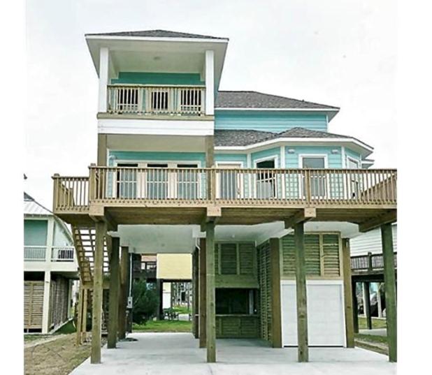 a large house with a deck on top of it at #Latitude Adjustment Home in Bolivar Peninsula