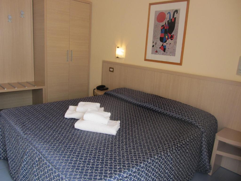 Postel nebo postele na pokoji v ubytování Hotel Nizza