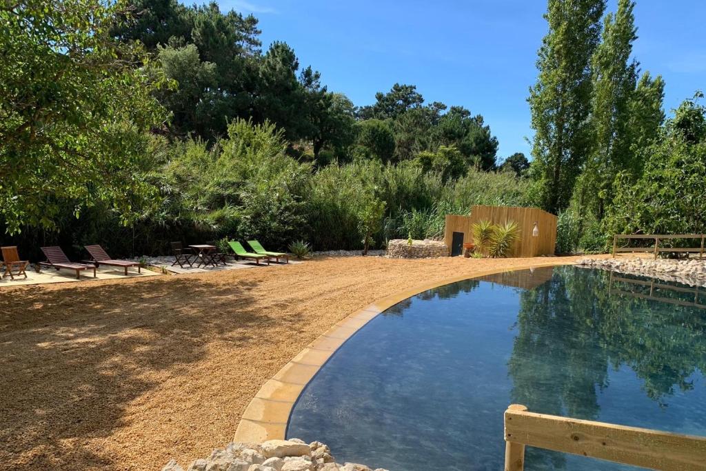 a swimming pool in the middle of a yard at Quinta do Meco - Beach & Nature in Aldeia do Meco