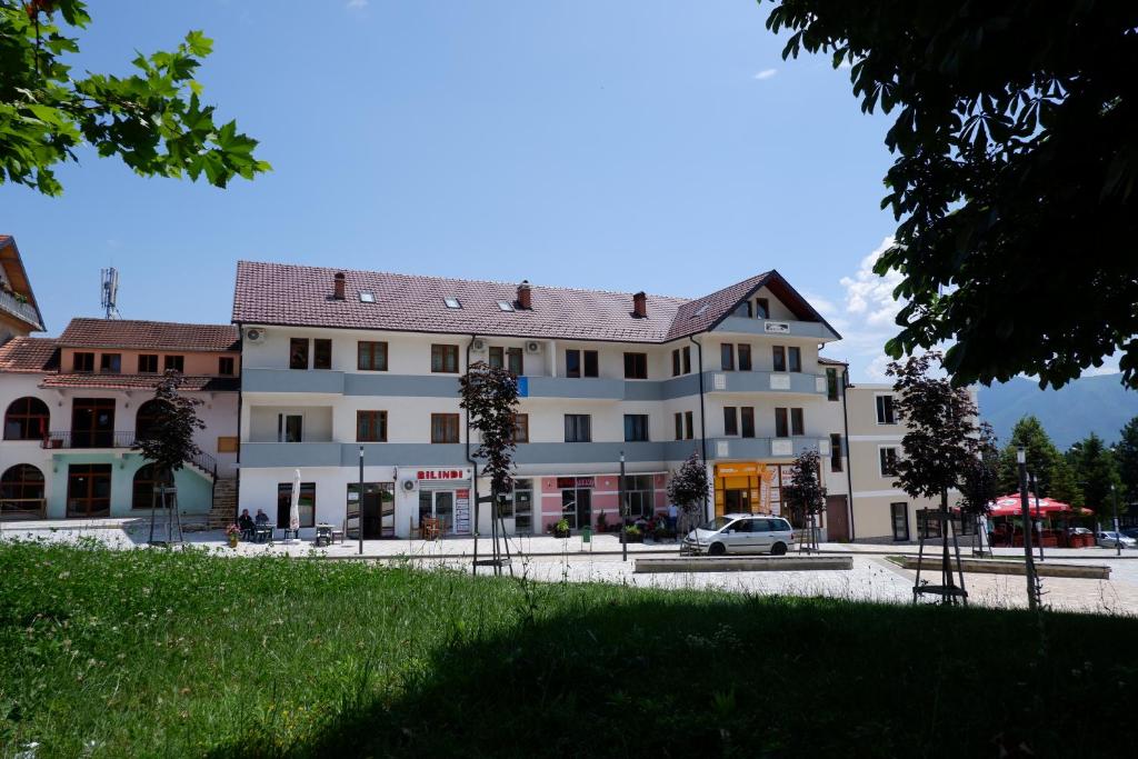 a building with a car parked in front of it at Kings Apartment 4 in Kolgecaj
