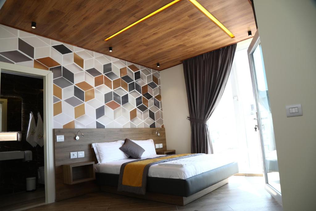Postel nebo postele na pokoji v ubytování Vila One Beach Hotel
