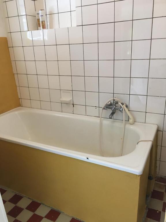 a bath tub with a faucet in a bathroom at Ubytování U Trůdy in Smržovka