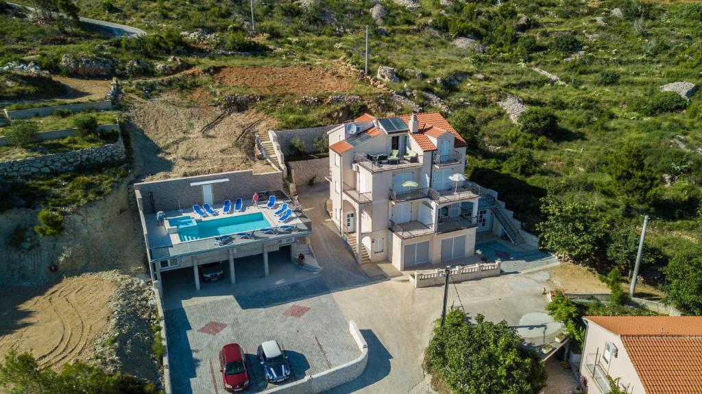 an aerial view of a house with a swimming pool at Apartments Pušić in Omiš