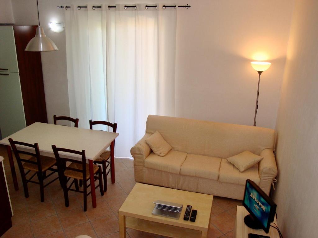 a living room with a couch and a table at Alba Blu in Santa Caterina Dello Ionio Marina